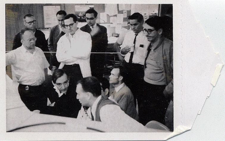 Group standing around monitors in Control Room