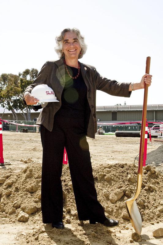 Persis Drell with hard hat and shovel